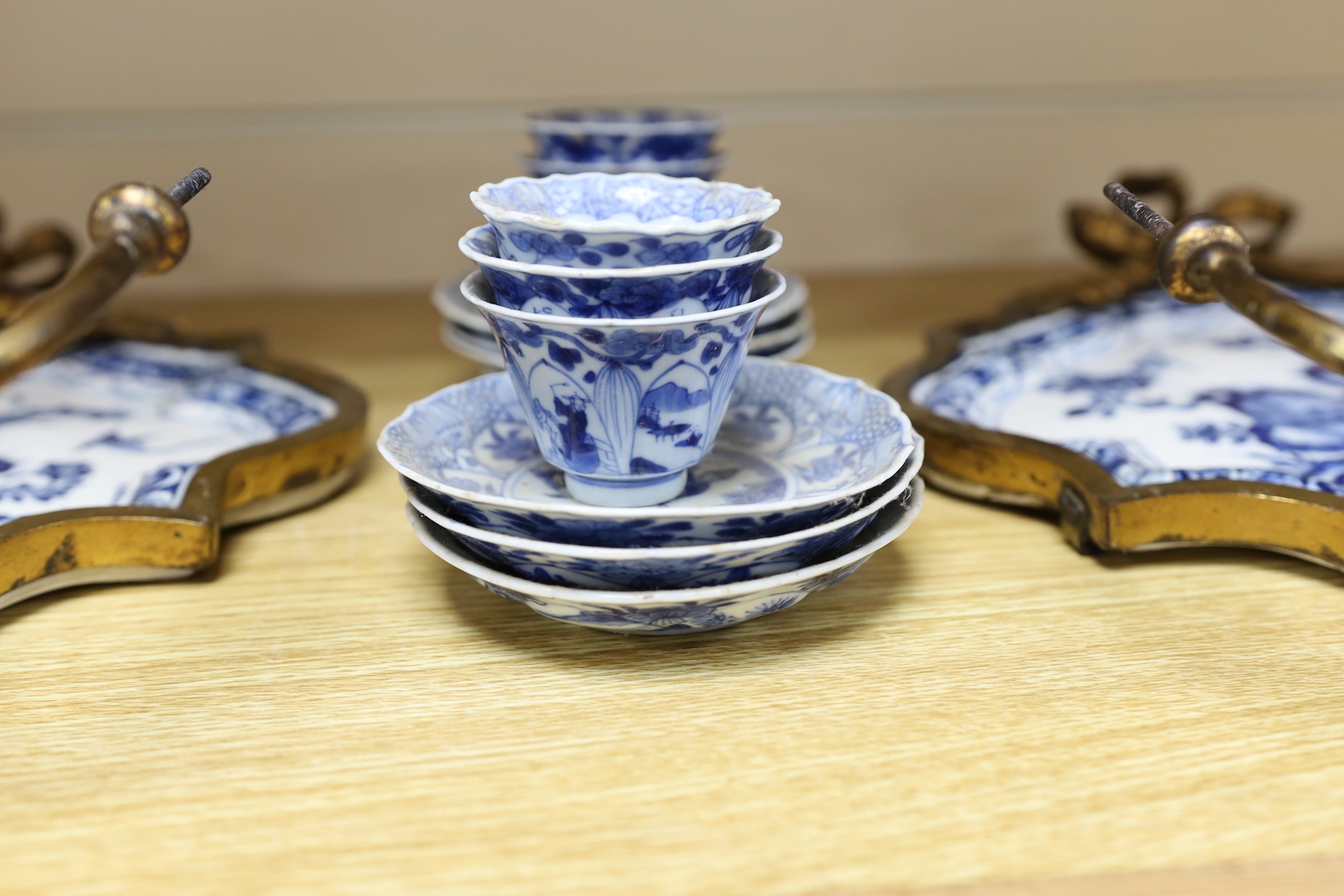 A pair of 19th century ormolu blue and white Delft wall sconces and with blue and white Chinese tea bowls and saucers forming the drip pans